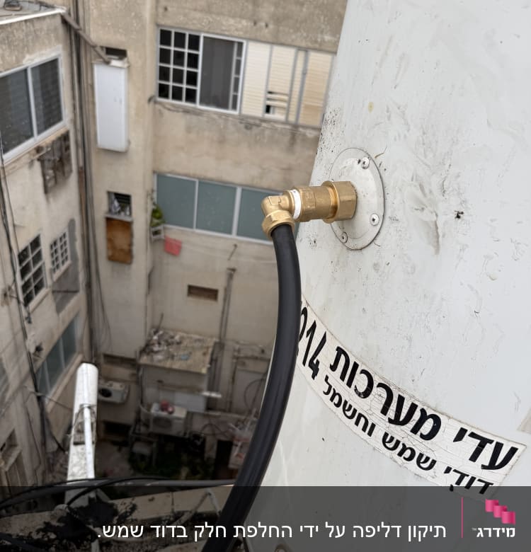 דוד שמש עם חיבורי צנרת על גג בניין
